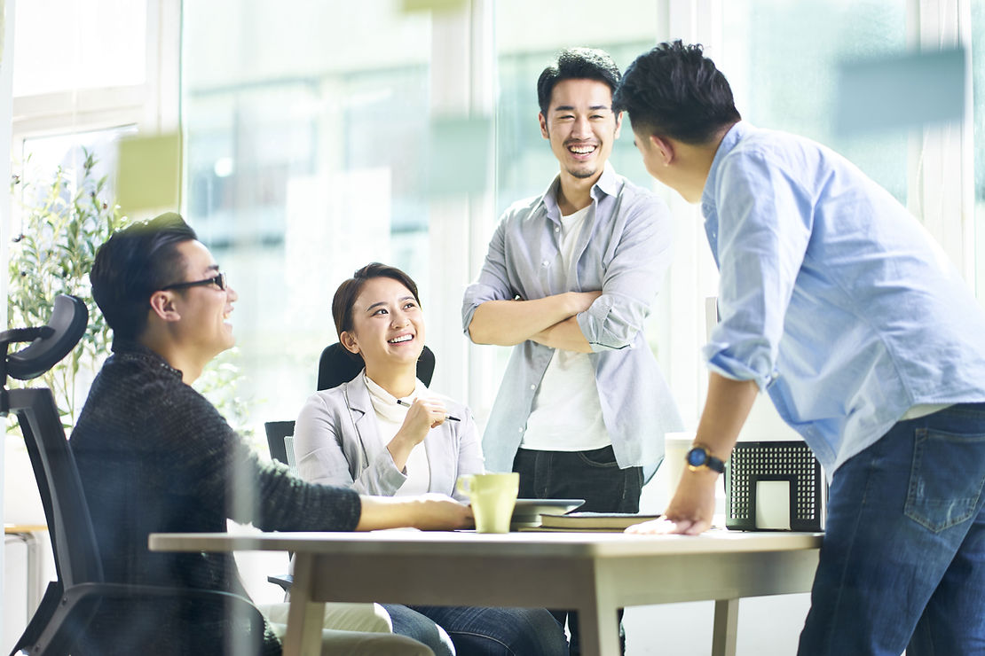 Group of people around a table smiling