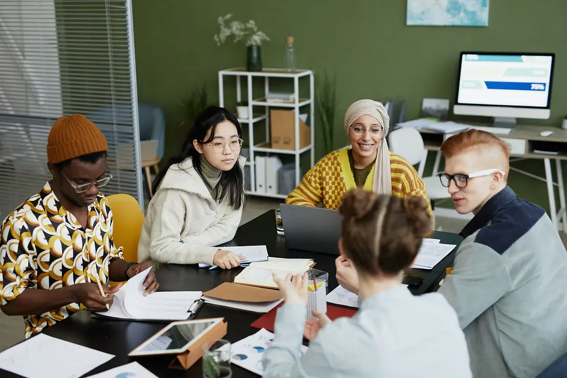 Group of people sitting around a table working