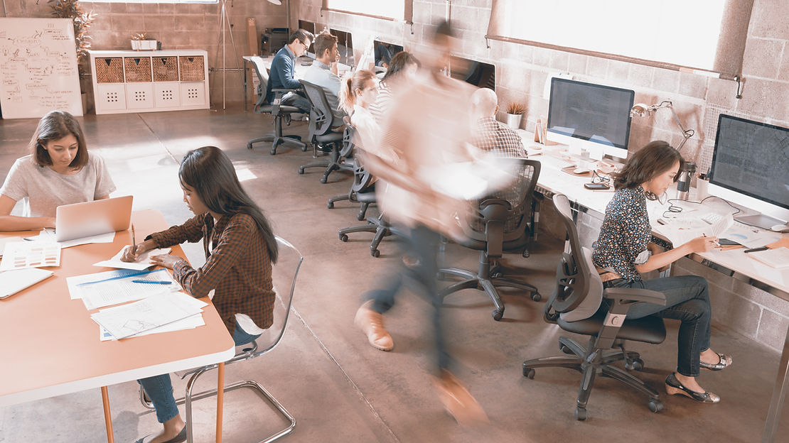 Office setting with a blurry person walking by