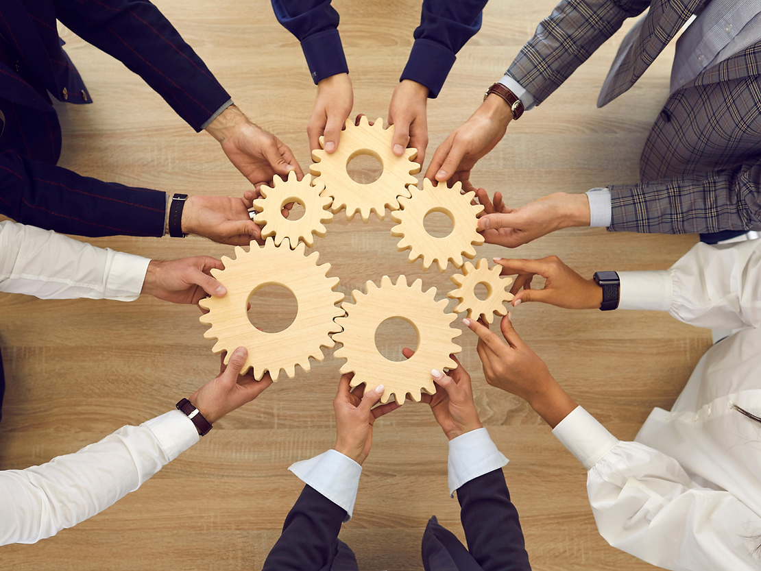 People holding wooden gears together