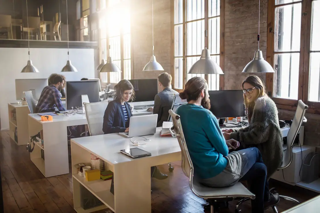 People in an office working and talking