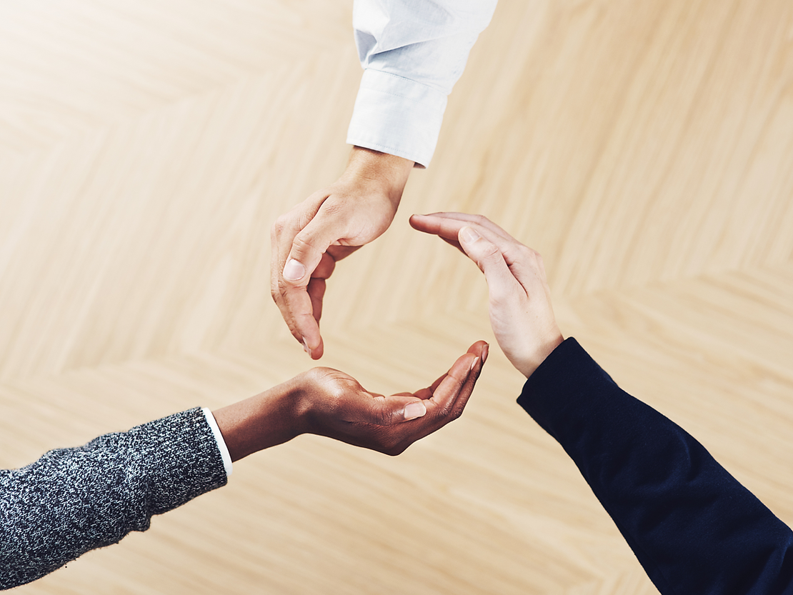 Person holding piece of paper with the word teamwork