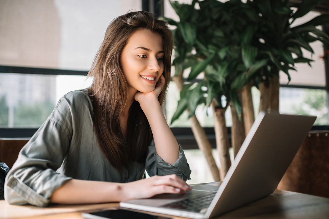 Woman smiling working on a laptop